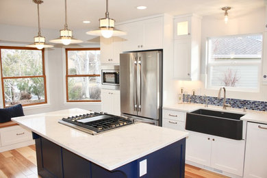 Inspiration for a transitional light wood floor eat-in kitchen remodel in Other with shaker cabinets, blue cabinets, quartz countertops and stainless steel appliances