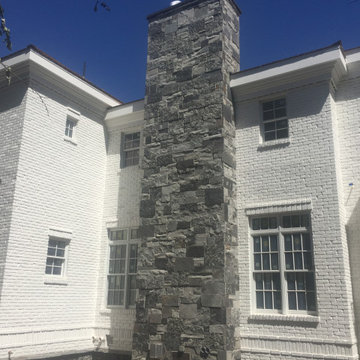 All natural stone veneer chimney.