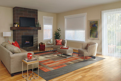 Inspiration for a mid-sized contemporary open concept light wood floor and brown floor family room remodel in Las Vegas with beige walls, a standard fireplace, a tile fireplace and a tv stand