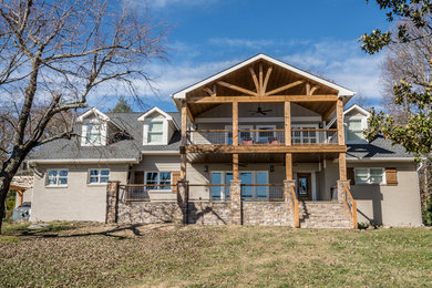 Inspiration for a large rustic brown two-story concrete fiberboard exterior home remodel in Nashville with a shingle roof