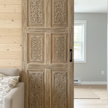 Antique Carved Barn Doors into a Spanish-Style Farmhouse
