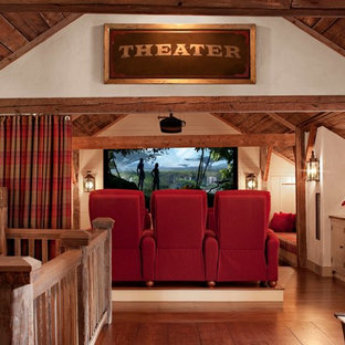 Design ideas for a large rural home cinema in New York with white walls, medium hardwood flooring and a projector screen.