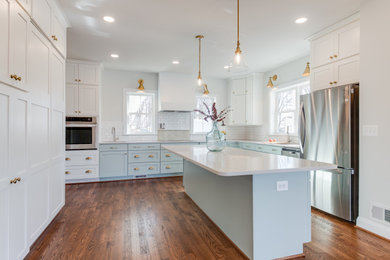 Inspiration for a large country l-shaped medium tone wood floor and brown floor kitchen pantry remodel in DC Metro with an undermount sink, shaker cabinets, blue cabinets, quartz countertops, white backsplash, subway tile backsplash, stainless steel appliances, an island and white countertops