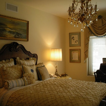 Elaborate window treatments, bedding and chandeier in this lady's bedroom