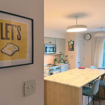 Curated Condo: Eclectic Kitchen, Light Wood Island, Veined Quartz