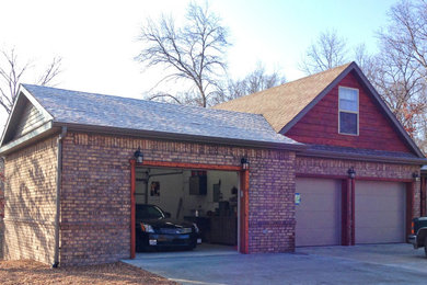 Garage - mid-sized attached three-car garage idea in Other