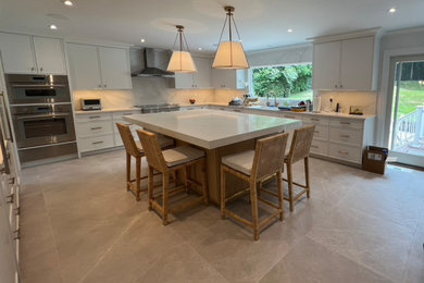 Inspiration for a large contemporary porcelain tile kitchen remodel in New York with an undermount sink, shaker cabinets, white cabinets and an island