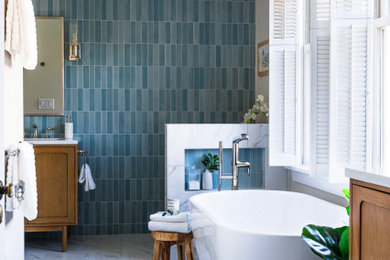Example of a small transitional master blue tile single-sink bathroom design in Seattle with quartz countertops, a hinged shower door and a freestanding vanity