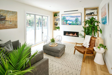 Example of a transitional enclosed light wood floor family room design in Vancouver with white walls