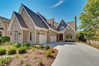 Large elegant beige one-story wood house exterior photo in Chicago with a hip roof and a shingle roof