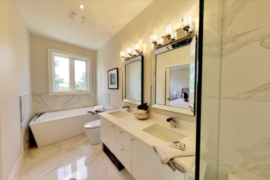 Example of a mid-sized trendy master white tile and porcelain tile porcelain tile bathroom design in Toronto with an undermount sink, flat-panel cabinets, white cabinets, quartzite countertops, a two-piece toilet and white walls