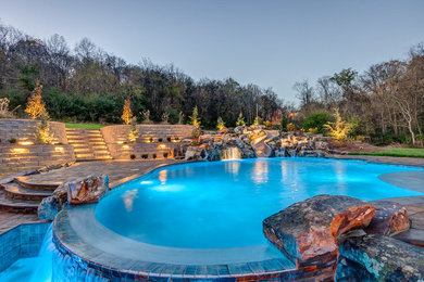 This is an example of a mid-sized contemporary backyard pool in Nashville with concrete pavers.