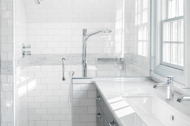 Alcove shower - traditional white tile and subway tile alcove shower idea in New York with an undermount sink, flat-panel cabinets and gray cabinets