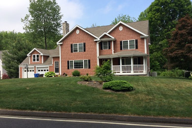 Large elegant brown two-story wood gable roof photo in New York
