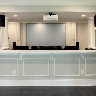 Photo of a large contemporary open plan home cinema in Philadelphia with beige walls, carpet, a projector screen and beige floors.