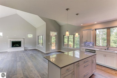 Mid-sized trendy l-shaped vinyl floor and brown floor eat-in kitchen photo in Other with a single-bowl sink, shaker cabinets, white cabinets, quartzite countertops, gray backsplash, ceramic backsplash, stainless steel appliances, an island and gray countertops