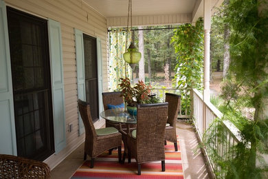 Inspiration for a small country concrete side porch remodel in Chicago with a roof extension