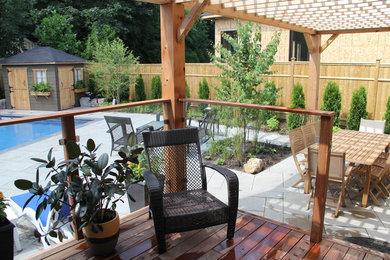 Example of a large beach style backyard stone and rectangular lap pool house design in Toronto