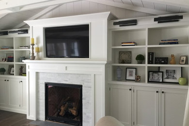 Inspiration for a mid-sized transitional open concept dark wood floor family room remodel in San Francisco with white walls, a standard fireplace, a stone fireplace and a media wall