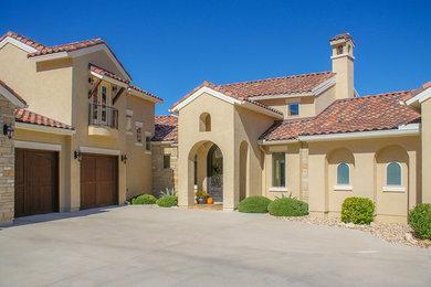 Inspiration for a mediterranean two-storey stucco beige exterior in Austin with a gable roof.