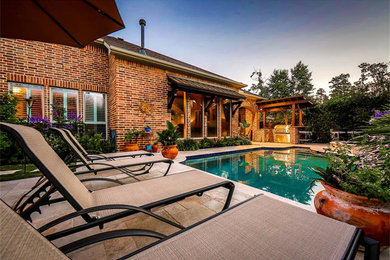 Patio - large transitional backyard stone patio idea in Houston with no cover