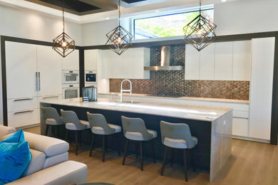 Open concept kitchen - large contemporary l-shaped coffered ceiling open concept kitchen idea in Miami with a single-bowl sink, flat-panel cabinets, white cabinets, quartzite countertops, metallic backsplash, metal backsplash, paneled appliances, an island and white countertops