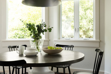 Example of a small transitional medium tone wood floor breakfast nook design in San Francisco with white walls
