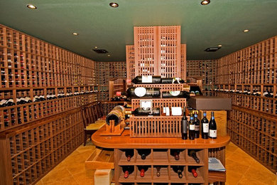 This is an example of a large traditional wine cellar in San Francisco with ceramic floors and display racks.