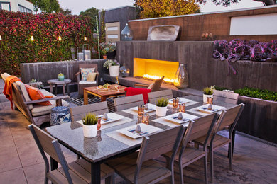 Patio kitchen - large modern backyard stamped concrete patio kitchen idea in San Francisco with no cover