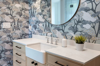 Example of a large transitional kids' blue tile and ceramic tile single-sink, porcelain tile, gray floor and wallpaper alcove shower design in Toronto with flat-panel cabinets, medium tone wood cabinets, a built-in vanity, a one-piece toilet, blue walls, a vessel sink, quartz countertops, a hinged shower door and gray countertops