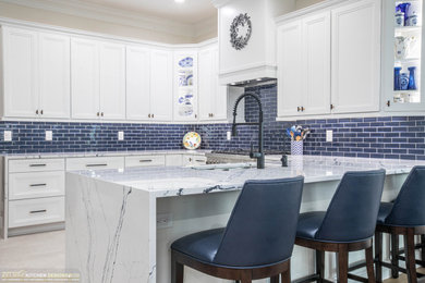 Example of a mid-sized transitional u-shaped porcelain tile kitchen design in Orlando with recessed-panel cabinets, white cabinets, quartz countertops and multicolored countertops