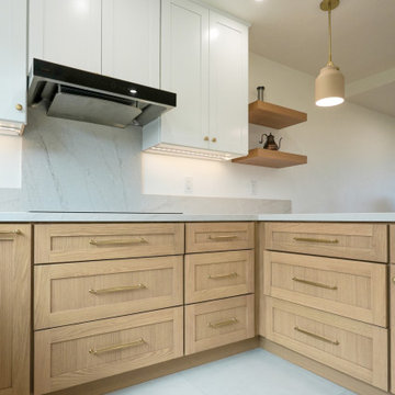 Modern White and Natural Oak Kitchen with Brass Hardware and Quartz Backsplash