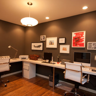 This is an example of a modern home office and library in Seattle with brown walls.