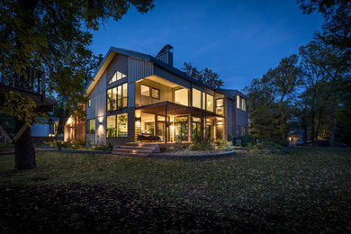 Minimalist beige two-story concrete fiberboard exterior home photo in Other with a metal roof