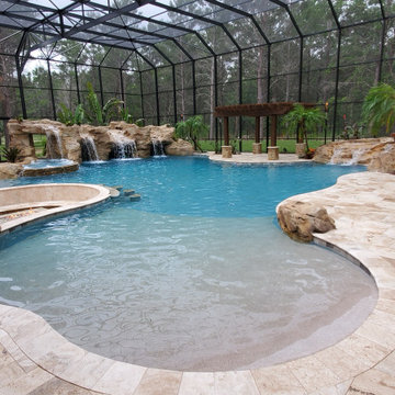 Resort Inspired Pool with Grotto and Sunken Firepit Lounge