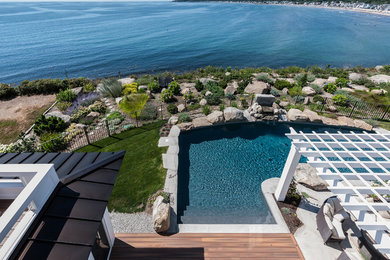 Large transitional backyard concrete and l-shaped natural pool photo in San Diego
