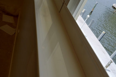 Small minimalist master white floor bedroom photo in Miami with white walls