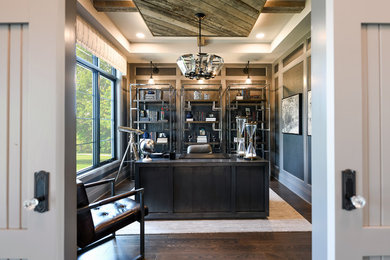 Mid-sized transitional freestanding desk dark wood floor and gray floor home office library photo in Detroit with gray walls