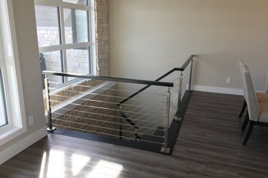 Example of a mid-sized trendy wooden u-shaped cable railing staircase design in Other with wooden risers
