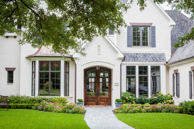 This is an example of a large traditional partial sun front yard stone formal garden in Dallas.