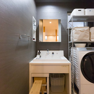 Photo of a small industrial utility room in Other with a built-in sink, grey walls, concrete flooring and grey floors.
