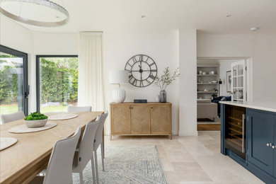 Design ideas for a contemporary kitchen/dining room in Other with white walls, limestone flooring and beige floors.