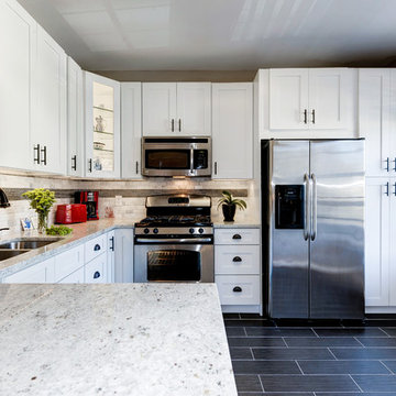 White Kitchen Remodel with Colonial White Granite and Stainless Steel Appliances