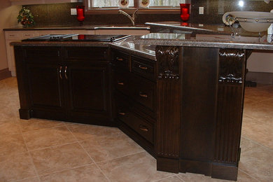 Example of a classic kitchen design in Toronto with raised-panel cabinets, dark wood cabinets and an island