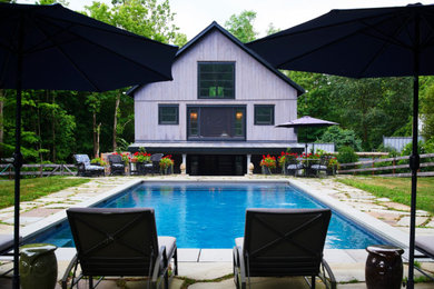 Mid-sized cottage stone and rectangular aboveground pool house photo in New York