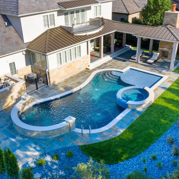 Naperville, IL freeform swimming pool with hot tub, large sunshelf, glass tile