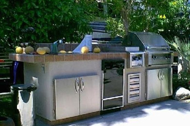 Inspiration for a large timeless backyard brick patio remodel in Los Angeles with a fire pit and no cover