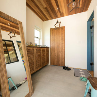 他の地域のビーチスタイルのおしゃれな玄関ホール (白い壁、コンクリートの床、グレーの床) の写真