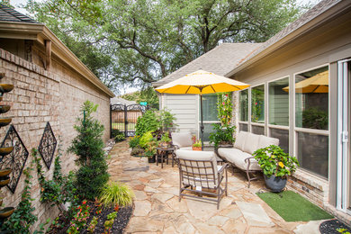 Mid-sized eclectic side yard stone patio photo in Dallas