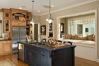 Example of a classic kitchen design in New York with an undermount sink, shaker cabinets, medium tone wood cabinets and stainless steel appliances